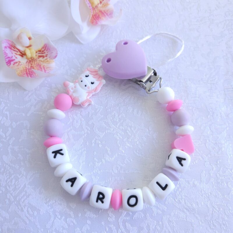 Nimeline lutikett Ükssarvik – roosa ja valge käsitöö lutikett beebile, valmistatud BPA-vabast silikoonist ja kaunistatud ükssarviku kujukesega.