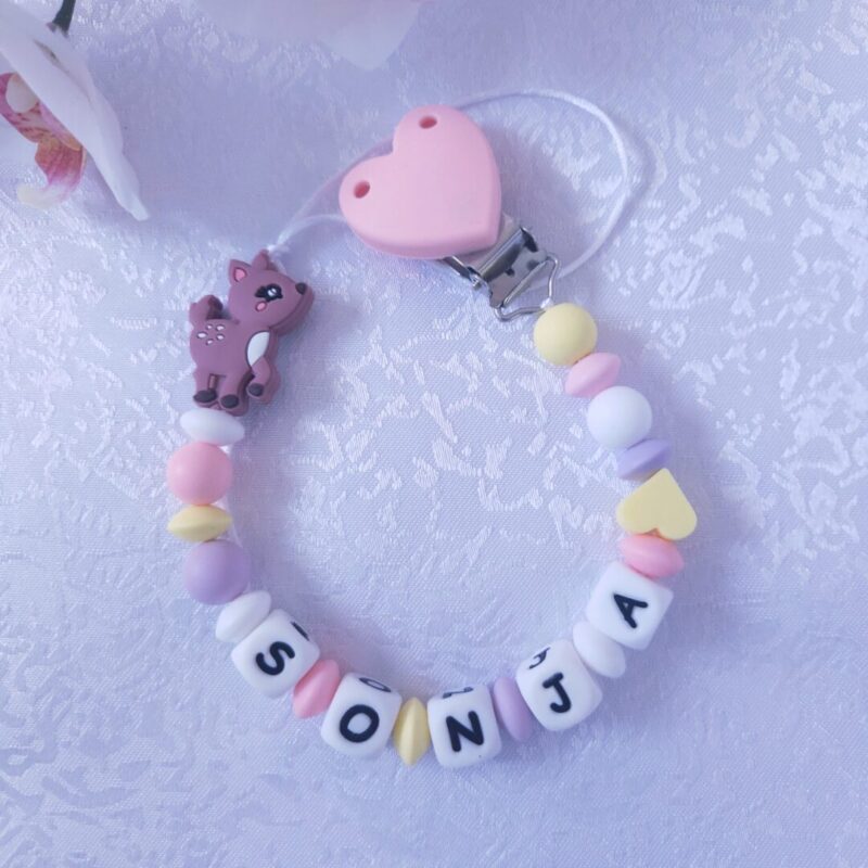 Nimeline lutikett Kitseke – roosa ja valge käsitöö lutikett beebile, valmistatud BPA-vabast silikoonist ja kaunistatud armsa kitsekese figuuriga.