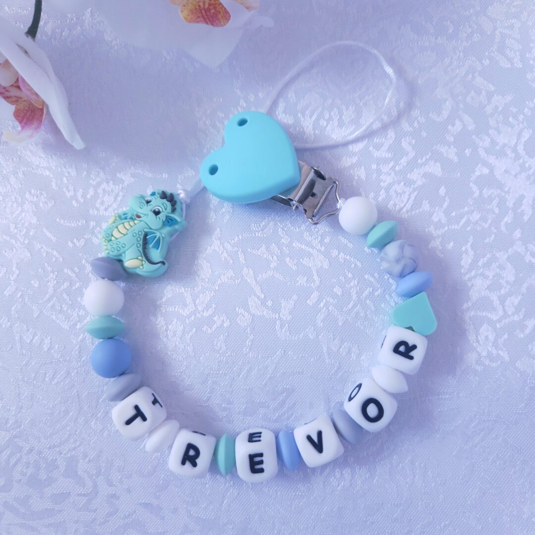 Nimeline lutikett Draakon – sinine käsitööna valmistatud BPA-vaba lutikett beebile, millel on südamekujuline klamber ja loomafiguur.